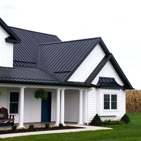 White Stucco House with Metal Roof and Black Shutters 